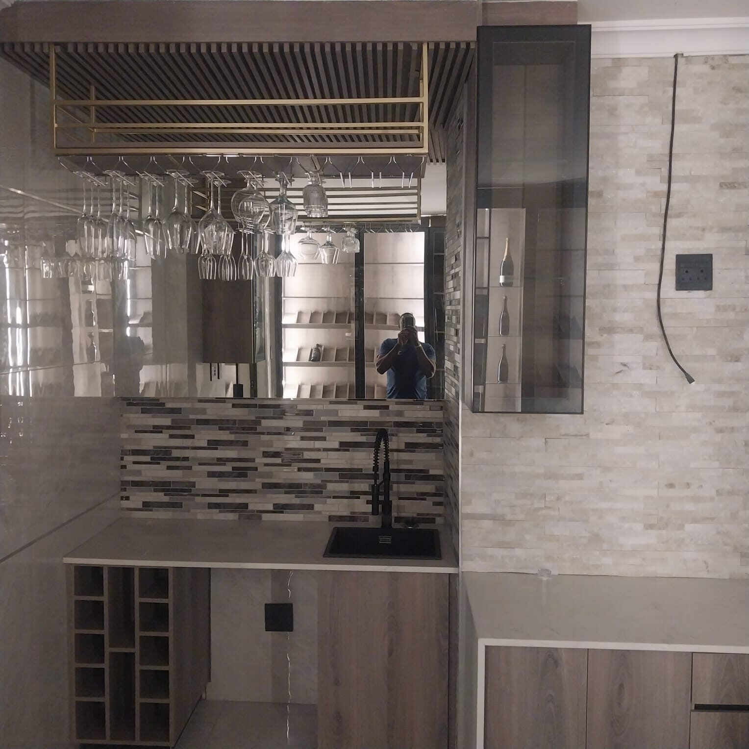 Built-in bar with brass stemware rack