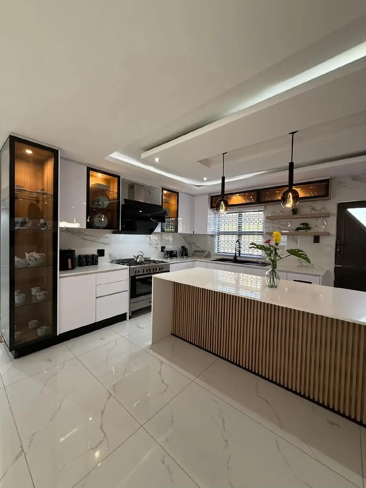 Open-plan kitchen with glass display cabinets