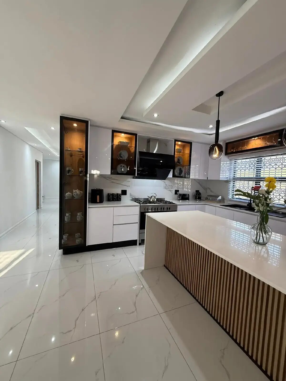 Grey gloss kitchen with cage pendant lighting