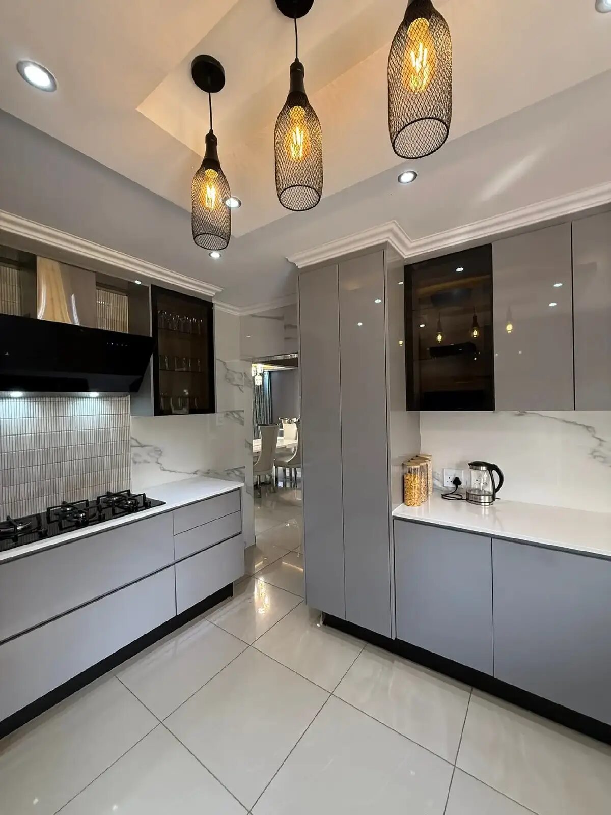 Grey kitchen with marble backsplash and black sink