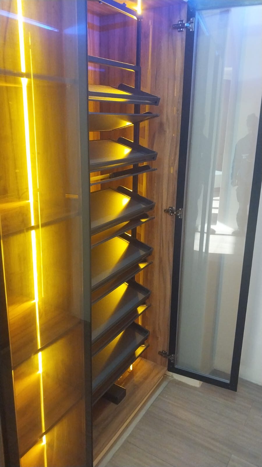 Built-in wardrobe with LED-lit pull-out rack