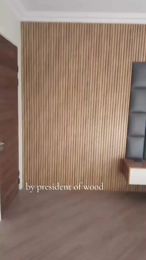 Wood-slat TV wall with floating shelf